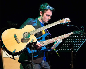 A shot of me playing my 7-string guitar dubbed 'Frankie', along with my acoustic.  This would've been taken during 'Radioactive', which required the intro to be played on the acoustic, and then subsequent verses and choruses on the 7-string.